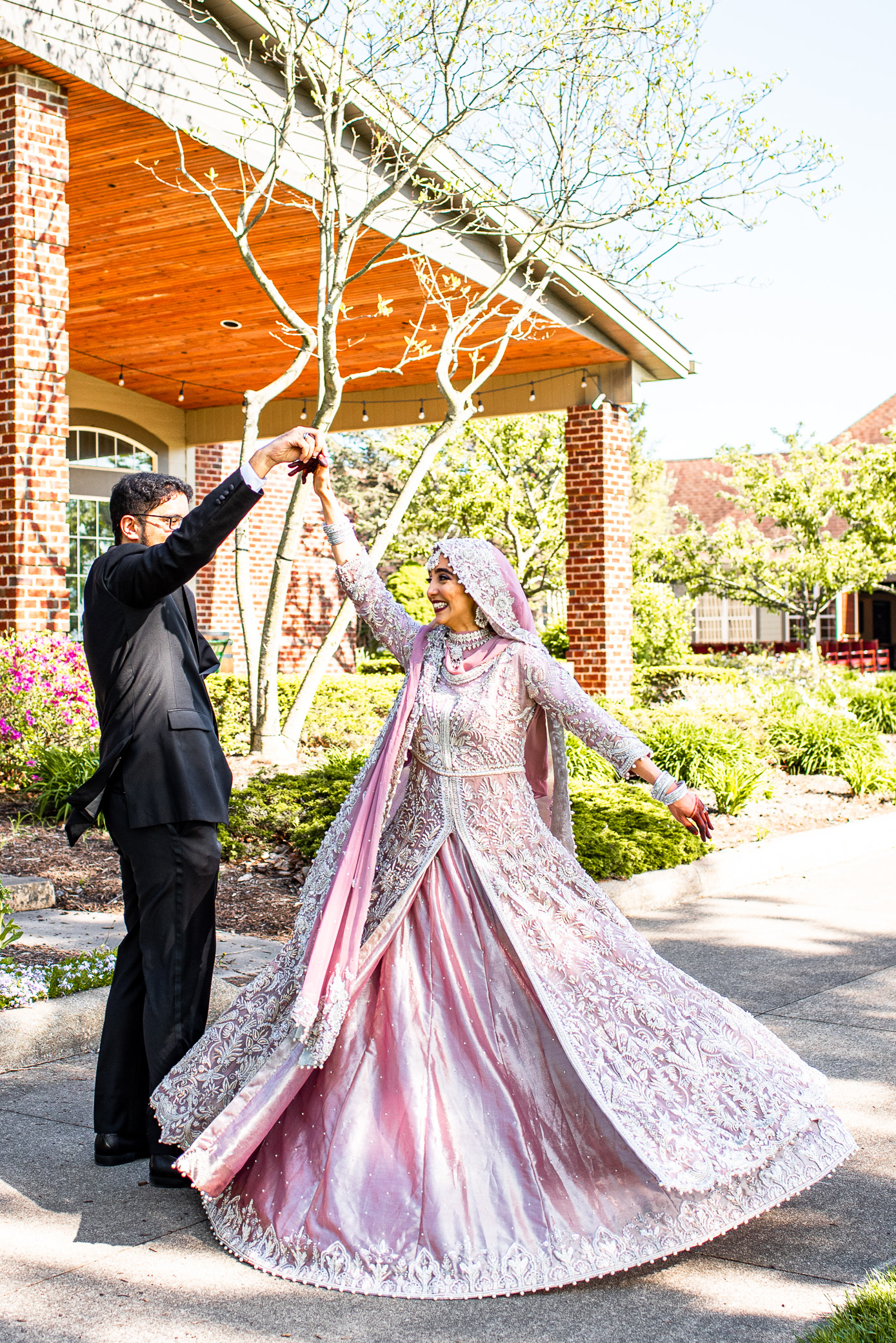 wedding photo of muslim bride twirling in pakistani bridal lehenga at weymouth country club in medina ohio